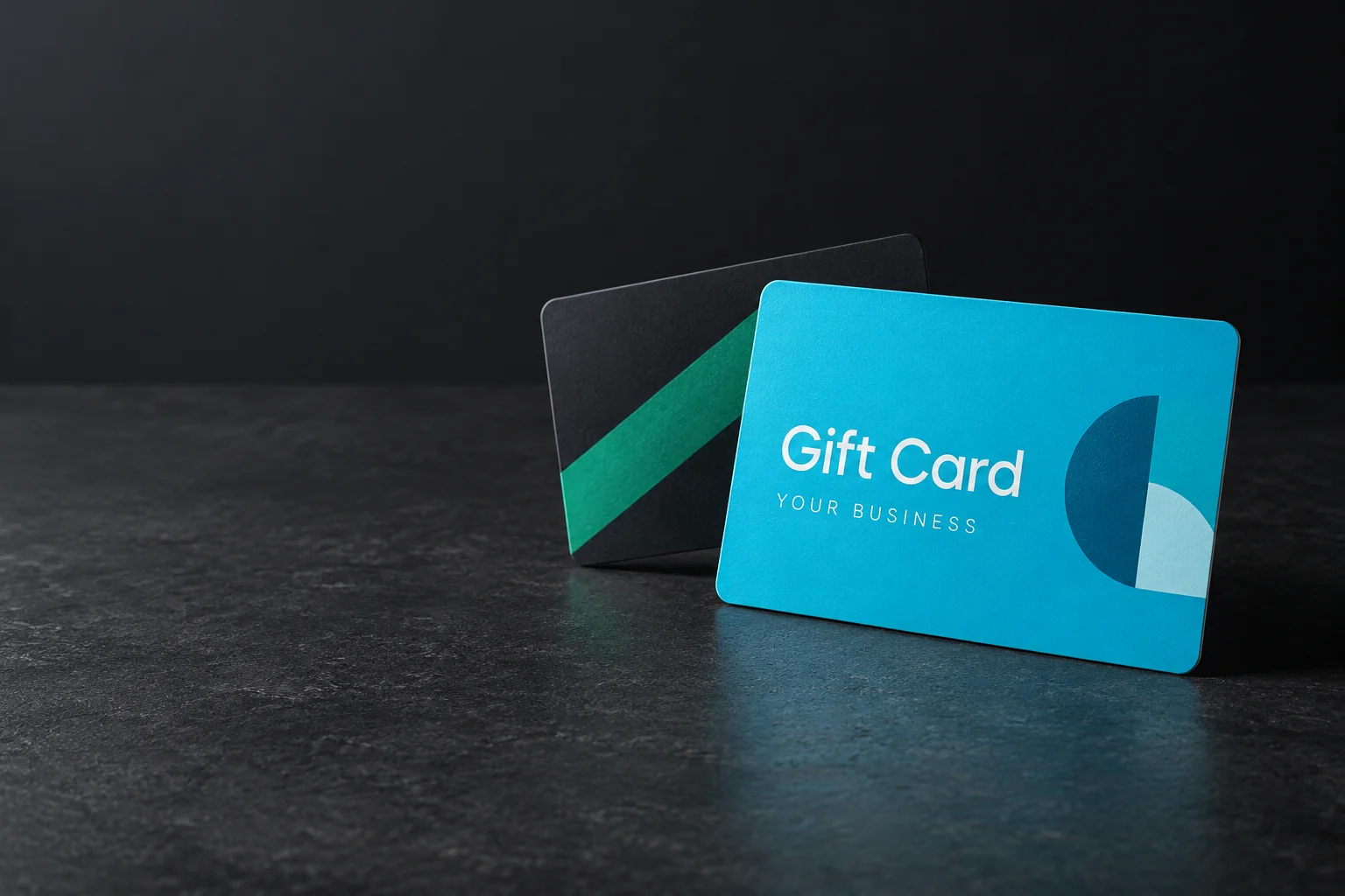 Illustrative cyan and charcoal gift card designs with space for a business brand.